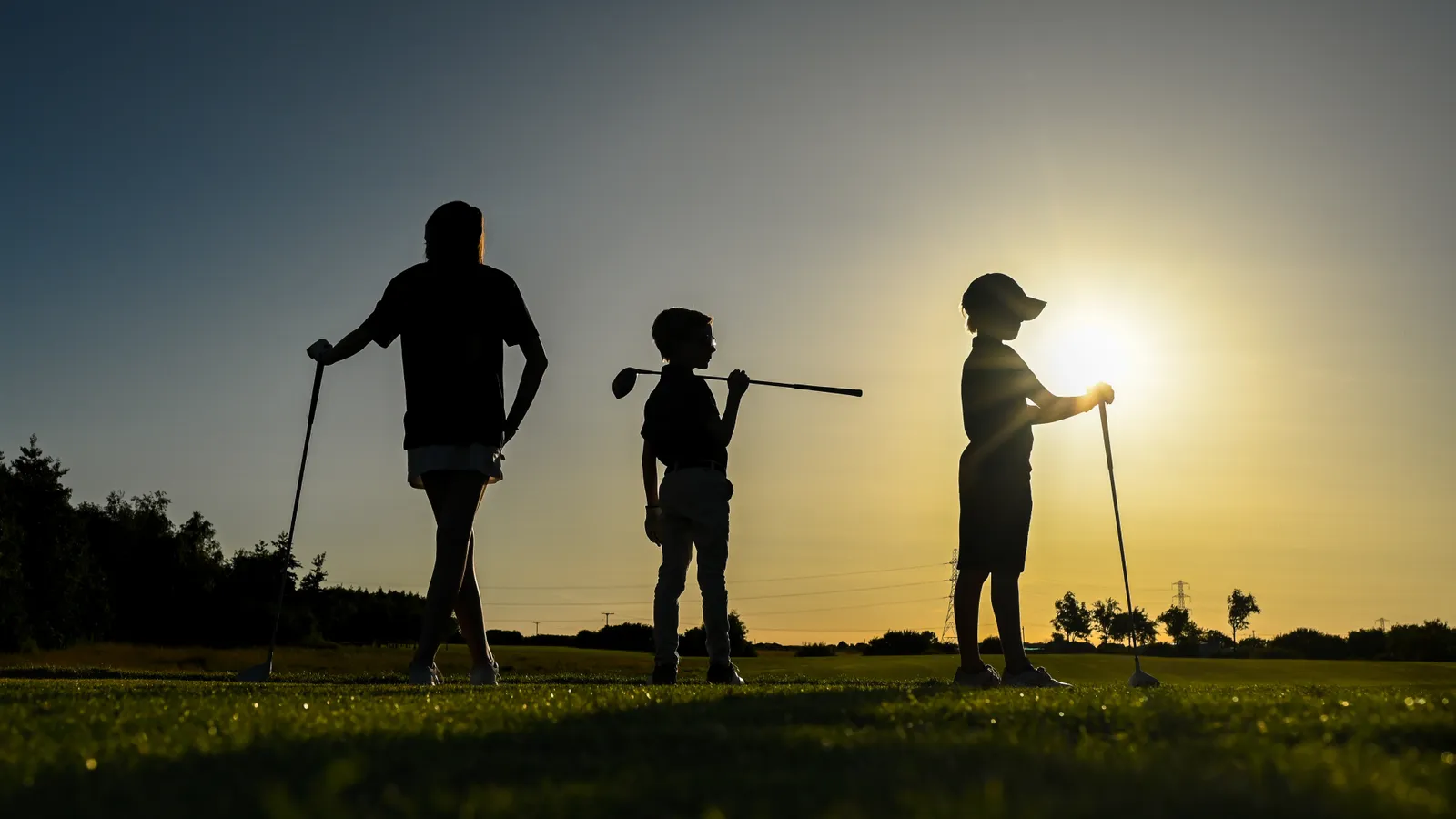 Silhouette of family playing golf on Staining Lodge Golf Course