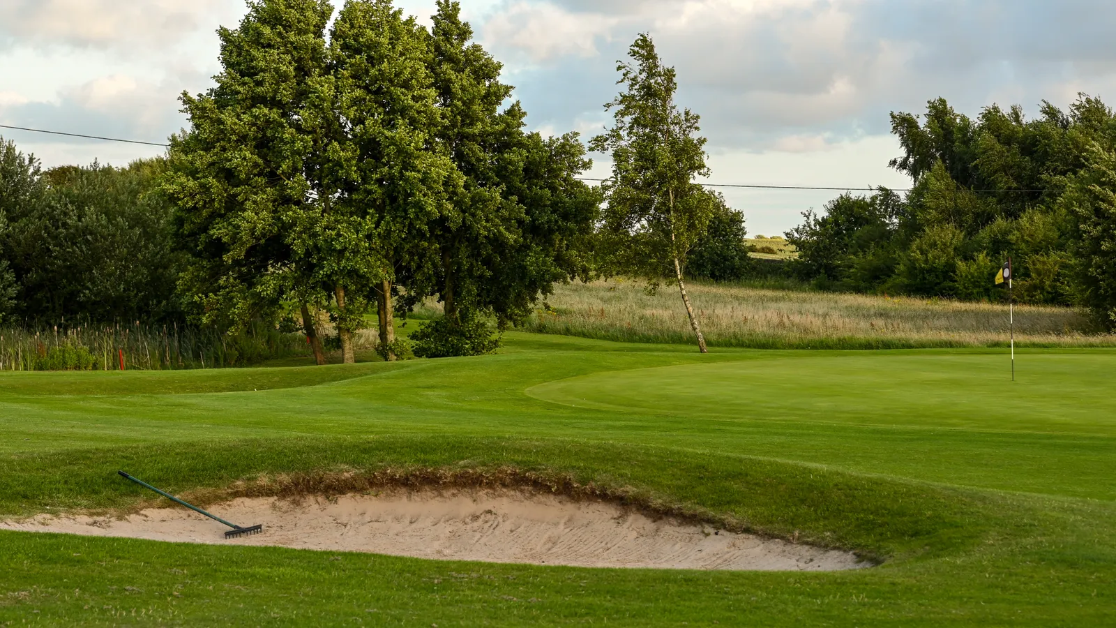 Flag and greens at Staining Lodge Golf Course